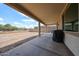 Spacious covered patio overlooking a vast backyard, offering seamless indoor-outdoor living at 6713 S 76Th Dr, Laveen, AZ 85339