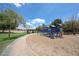 Community playground featuring modern play structures, a covered picnic area, and lush green space for outdoor activities at 6713 S 76Th Dr, Laveen, AZ 85339