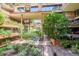 Lush courtyard with mature trees, water feature, and walkways offering a peaceful retreat for residents at 7157 E Rancho Vista Dr # 2012, Scottsdale, AZ 85251