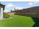 The backyard has a newly installed turf lawn at 7180 W Tombstone Trl, Peoria, AZ 85383