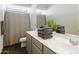Spacious bathroom with a double sink vanity, decorative mirror, and stylish design at 7180 W Tombstone Trl, Peoria, AZ 85383