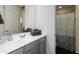 Bathroom with a modern vanity, framed mirror, and a shower with a decorative curtain at 7180 W Tombstone Trl, Peoria, AZ 85383