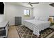 Modern bedroom with a neutral color scheme, natural light, and dark wooden drawers at 7180 W Tombstone Trl, Peoria, AZ 85383