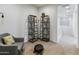 Cozy hallway featuring a gray chair and unique wooden shelving units at 7180 W Tombstone Trl, Peoria, AZ 85383