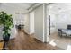 Open hallway features wood floors, white walls and trim, plus an office space and living room at 7180 W Tombstone Trl, Peoria, AZ 85383