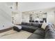 Living room features a corner couch, high ceilings, wood floors, and an open concept to the kitchen at 7180 W Tombstone Trl, Peoria, AZ 85383