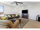 Comfortable living room with a large window, plush seating, and an entertainment center at 7180 W Tombstone Trl, Peoria, AZ 85383
