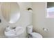 A simple powder room featuring a modern sink and a round mirror at 7180 W Tombstone Trl, Peoria, AZ 85383