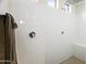 A tiled shower with a built-in bench, chrome shower fixtures, and natural light at 7180 W Tombstone Trl, Peoria, AZ 85383