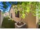 The home's backyard features a private fenced yard and an air conditioning unit nestled amidst lush green surroundings at 7317 S 37Th Gln, Phoenix, AZ 85041