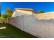 The backyard includes faux grass, a brick wall, and a view of the home's exterior with lush greenery at 7317 S 37Th Gln, Phoenix, AZ 85041