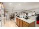 Open kitchen featuring wood cabinets, white appliances, and breakfast bar with tile floors at 7317 S 37Th Gln, Phoenix, AZ 85041