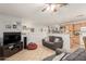 Bright living room leading to the kitchen with tile floors, ceiling fan and comfortable seating at 7317 S 37Th Gln, Phoenix, AZ 85041