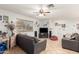 Bright living room features tile floors, a ceiling fan, and comfortable seating at 7317 S 37Th Gln, Phoenix, AZ 85041