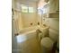 Bright bathroom with a tub/shower combo, a classic vanity, and tiled floor at 735 E Desert Ave, Apache Junction, AZ 85119