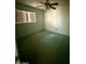 Comfortable bedroom with light-colored walls, a ceiling fan, and a window at 735 E Desert Ave, Apache Junction, AZ 85119