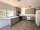 Well-lit kitchen boasts updated countertops, appliances, and plenty of cabinet space at 735 E Desert Ave, Apache Junction, AZ 85119