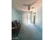 Living room with neutral walls, ceiling fan, and view of bathroom in back at 735 E Desert Ave, Apache Junction, AZ 85119