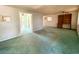 Spacious living room features neutral walls, wall unit and doorway leading to the back at 735 E Desert Ave, Apache Junction, AZ 85119