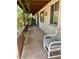 Inviting porch with a stained concrete floor and plenty of room for outdoor seating at 735 E Desert Ave, Apache Junction, AZ 85119