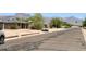 Street view showcasing the home's location and neighborhood with views of the mountains in the distance at 735 E Desert Ave, Apache Junction, AZ 85119