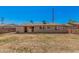 Back exterior of the home, showing the large backyard with both grassy and dry areas at 7359 N 39Th Ave, Phoenix, AZ 85051