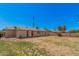 Backyard featuring partial grass, block wall and view of the back exterior of the home at 7359 N 39Th Ave, Phoenix, AZ 85051