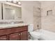 Bathroom featuring granite countertops, vanity, and a tub with a tiled wall at 7359 N 39Th Ave, Phoenix, AZ 85051
