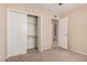 A well-lit bedroom with neutral walls, closet, carpet, and an open doorway to the home's bathroom at 7359 N 39Th Ave, Phoenix, AZ 85051