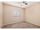 Cozy bedroom featuring neutral walls, carpet, ceiling fan, and a window providing natural light at 7359 N 39Th Ave, Phoenix, AZ 85051