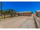 Home's exterior featuring a spacious driveway, well-maintained lawn, and mature shade tree at 7359 N 39Th Ave, Phoenix, AZ 85051