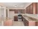 This kitchen features stone countertops, stainless steel appliances, and sleek wooden cabinetry at 7359 N 39Th Ave, Phoenix, AZ 85051