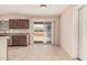 Bright eat-in kitchen boasts stone counters, wooden cabinetry, and sliding glass doors to the backyard at 7359 N 39Th Ave, Phoenix, AZ 85051