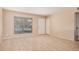 Neutral living room with tile flooring, bright window, and white door perfect for customization at 7359 N 39Th Ave, Phoenix, AZ 85051