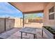 Covered back patio with a view of the backyard, featuring mature tree and block fence at 7405 W Elwood St, Phoenix, AZ 85043