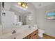 Bathroom with a double sink vanity, a large mirror, and a shower, offering convenience and functionality at 7405 W Elwood St, Phoenix, AZ 85043