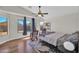 Bright bedroom featuring large windows, ceiling fan, wood floors and neutral walls at 7405 W Elwood St, Phoenix, AZ 85043