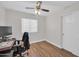 Bedroom features wood floors, neutral walls, and a ceiling fan with a window and closet for extra convenience at 7405 W Elwood St, Phoenix, AZ 85043