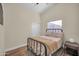 Bedroom features neutral walls, wood floors, and a ceiling fan with a window and closet for extra convenience at 7405 W Elwood St, Phoenix, AZ 85043