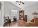Cozy bedroom featuring natural light, wood floors, book shelf, and comfortable sitting area at 7405 W Elwood St, Phoenix, AZ 85043