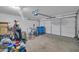 Spacious garage featuring a white door, bike, and ample storage space at 7405 W Elwood St, Phoenix, AZ 85043