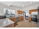 Well-lit kitchen featuring oak cabinetry, modern appliances, and tile flooring at 7405 W Elwood St, Phoenix, AZ 85043