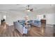 Open-concept living area featuring wood floors, comfortable seating, and ample natural light at 7405 W Elwood St, Phoenix, AZ 85043