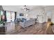 Spacious living room with wood floors, modern sofas, and sliding glass doors at 7405 W Elwood St, Phoenix, AZ 85043