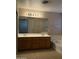 Bathroom featuring a double vanity, large mirror, bathtub, and neutral tile flooring at 7422 W Superior Ave, Phoenix, AZ 85043