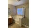 Bathroom featuring a large bathtub, glass enclosed shower, and modern fixtures at 7422 W Superior Ave, Phoenix, AZ 85043