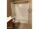 Neutral-toned bathroom features combination shower and tub with tile floors at 7422 W Superior Ave, Phoenix, AZ 85043