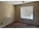 Bedroom with standard window letting in light and neutral colored walls at 7422 W Superior Ave, Phoenix, AZ 85043