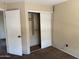 Bedroom features standard closet with sliding doors and neutral color walls at 7422 W Superior Ave, Phoenix, AZ 85043
