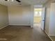 Bedroom with a ceiling fan, tan carpet, and access to the staircase at 7422 W Superior Ave, Phoenix, AZ 85043